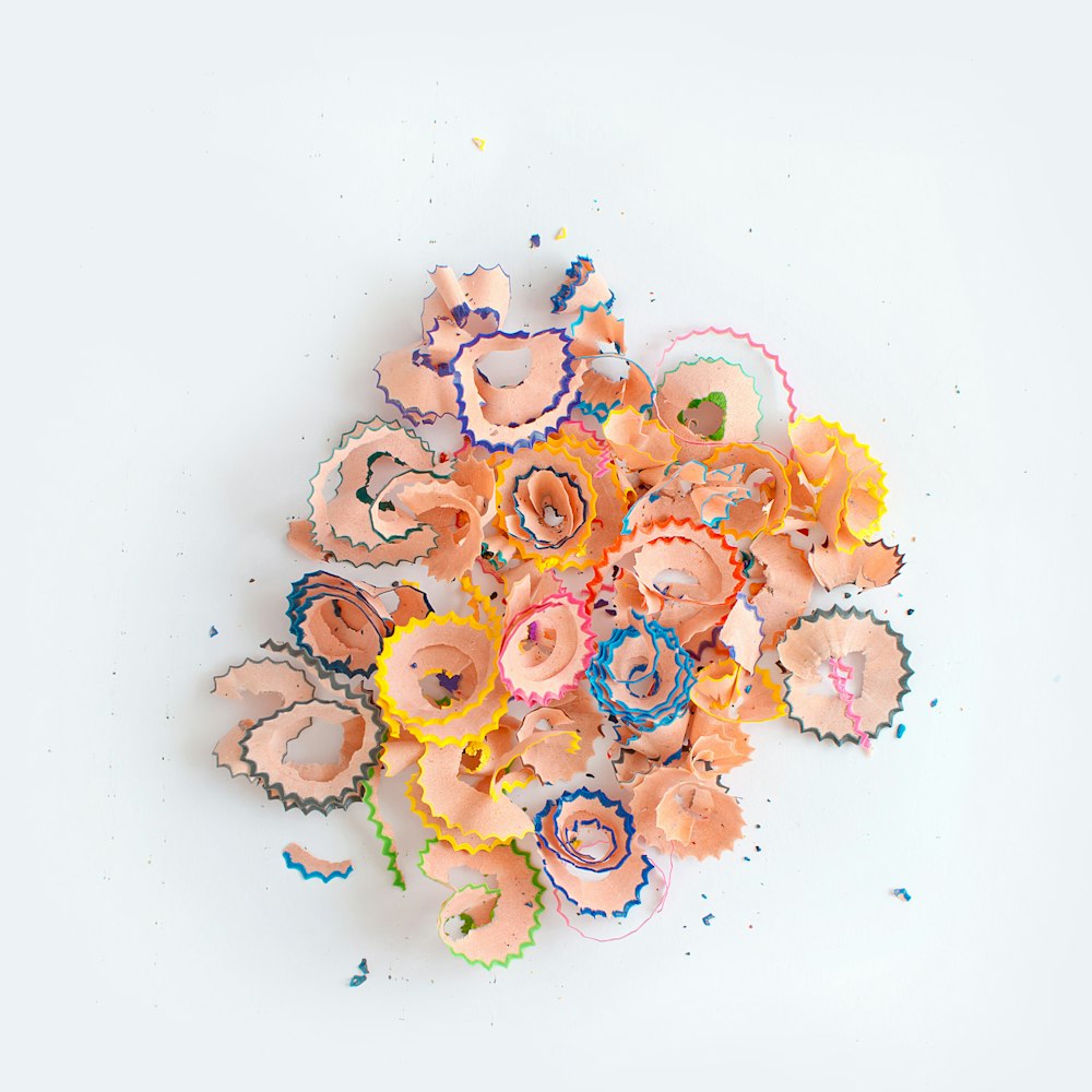 a pile of paper flowers sitting on top of a white table