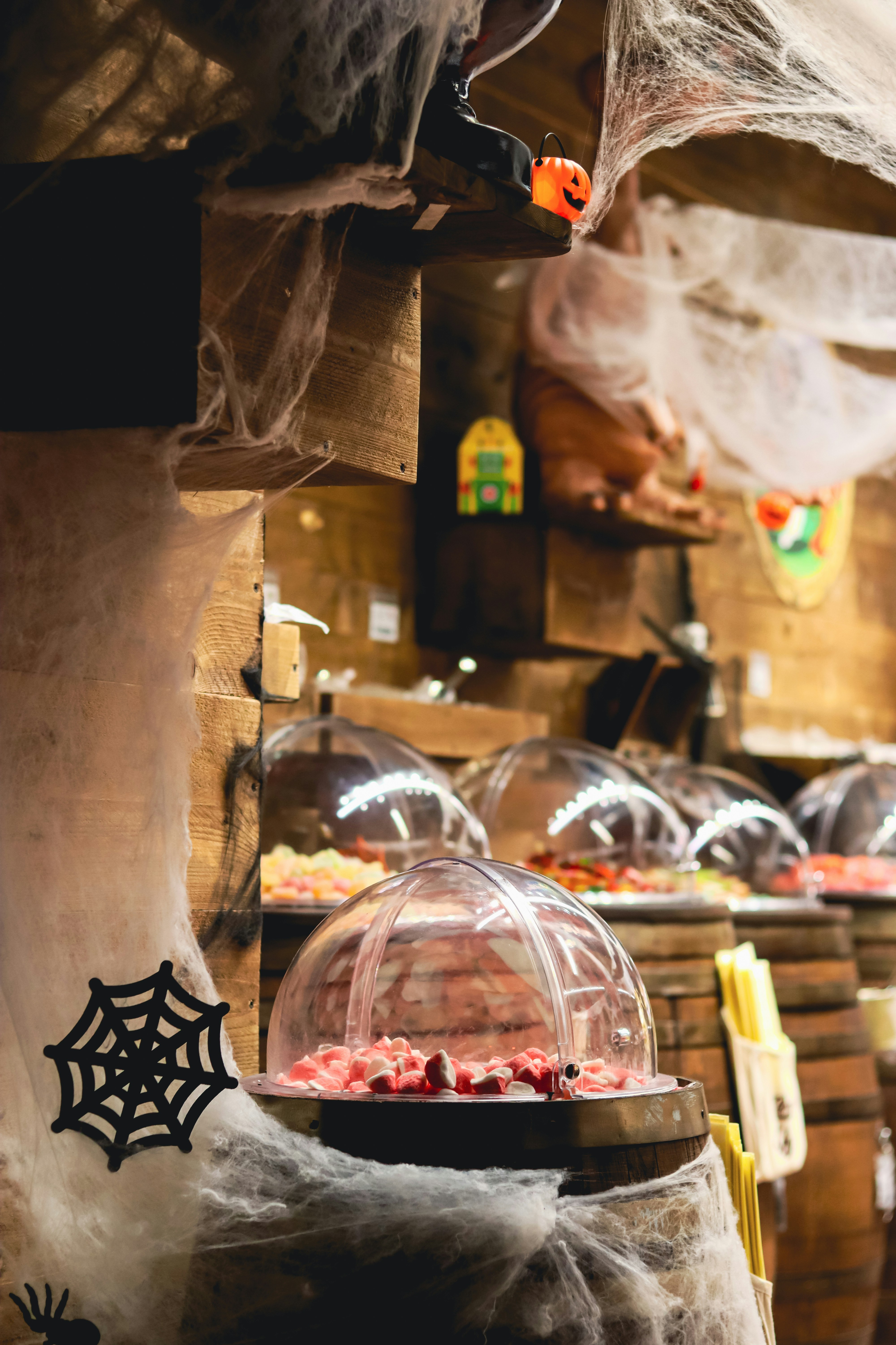 Halloween candy display with colorful sweets in dome containers.