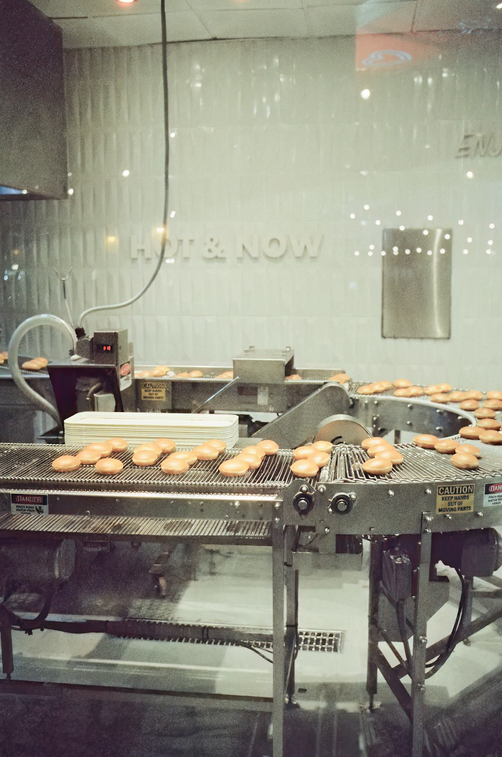 a conveyor belt with donuts on it