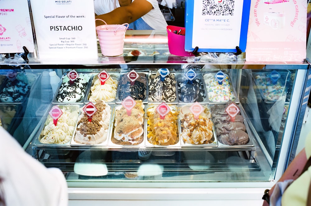 a display case filled with lots of different types of desserts