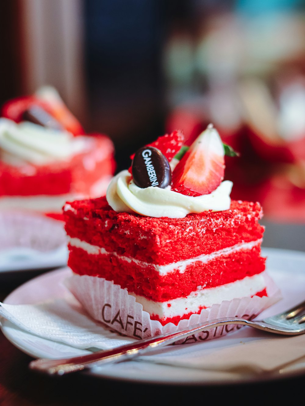 a piece of red velvet cake on a plate with a fork