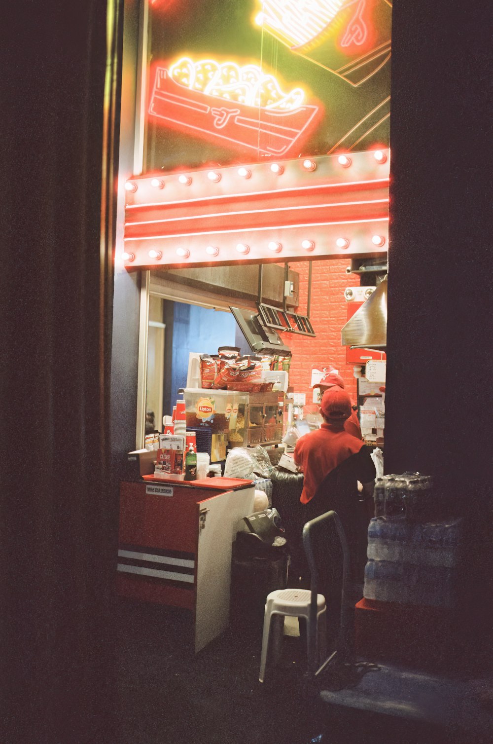 a man standing in front of a restaurant