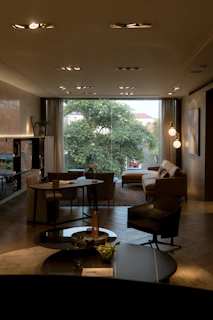 a living room filled with furniture and a large window