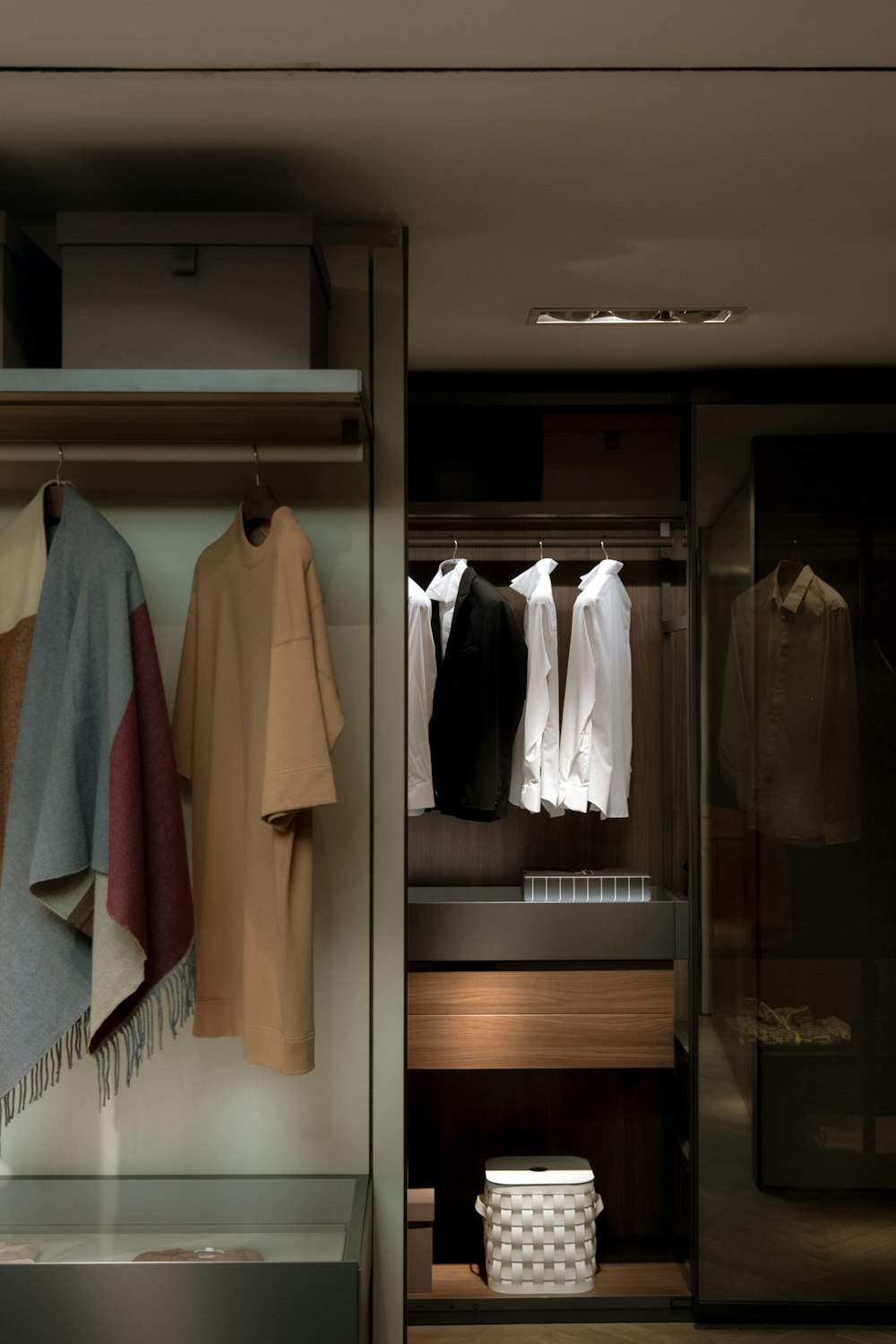 a closet with clothes hanging on a rail