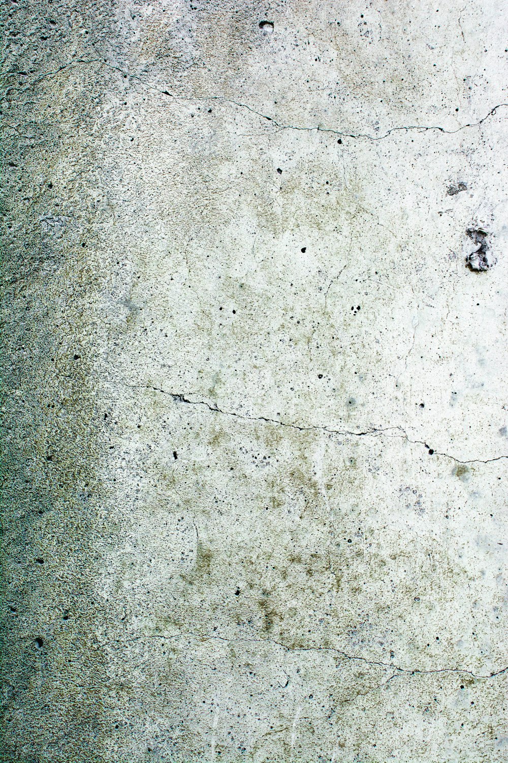 a close up of a cement surface with small cracks