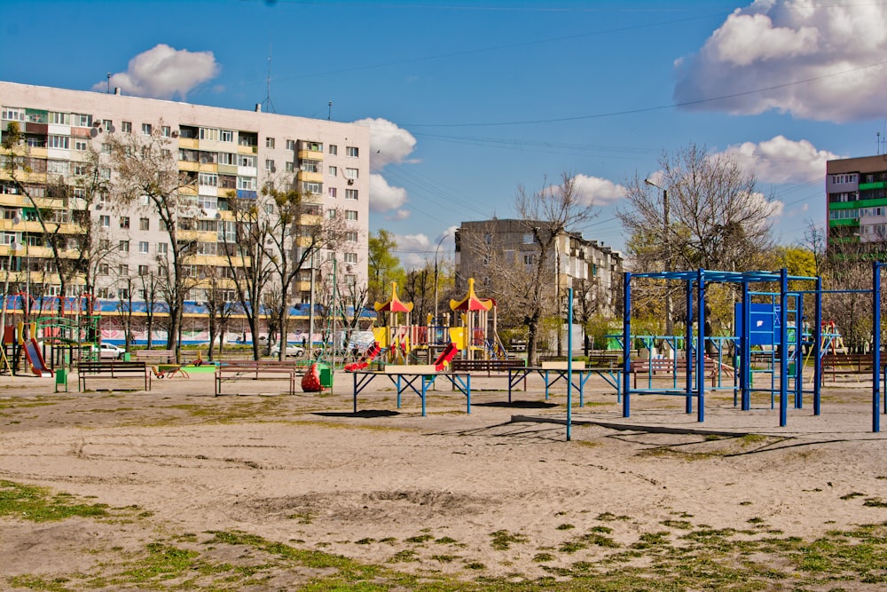 a playground in a city with a building in the background