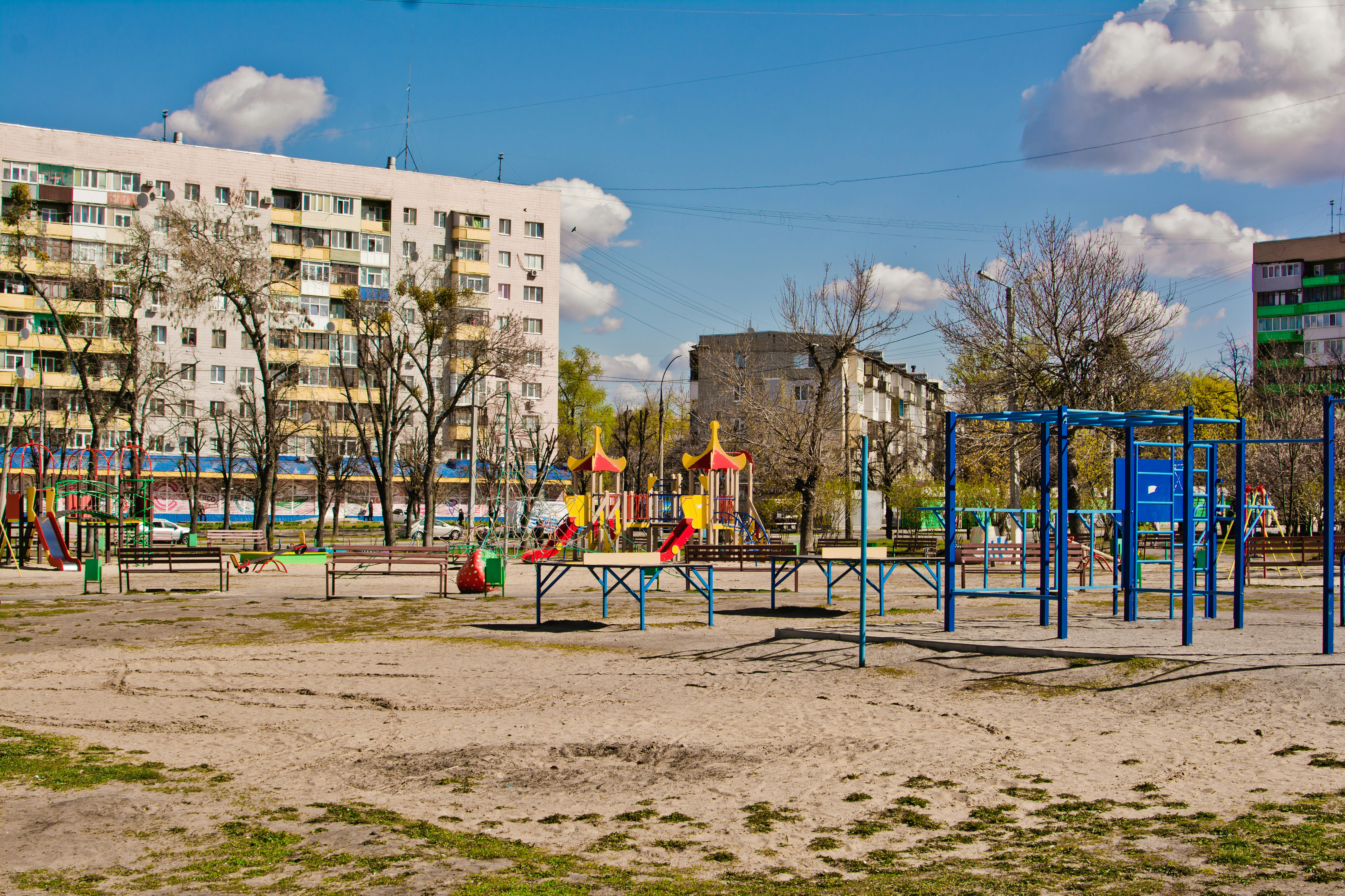 a playground in a city with a building in the background