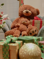 a brown teddy bear sitting on a chair with presents