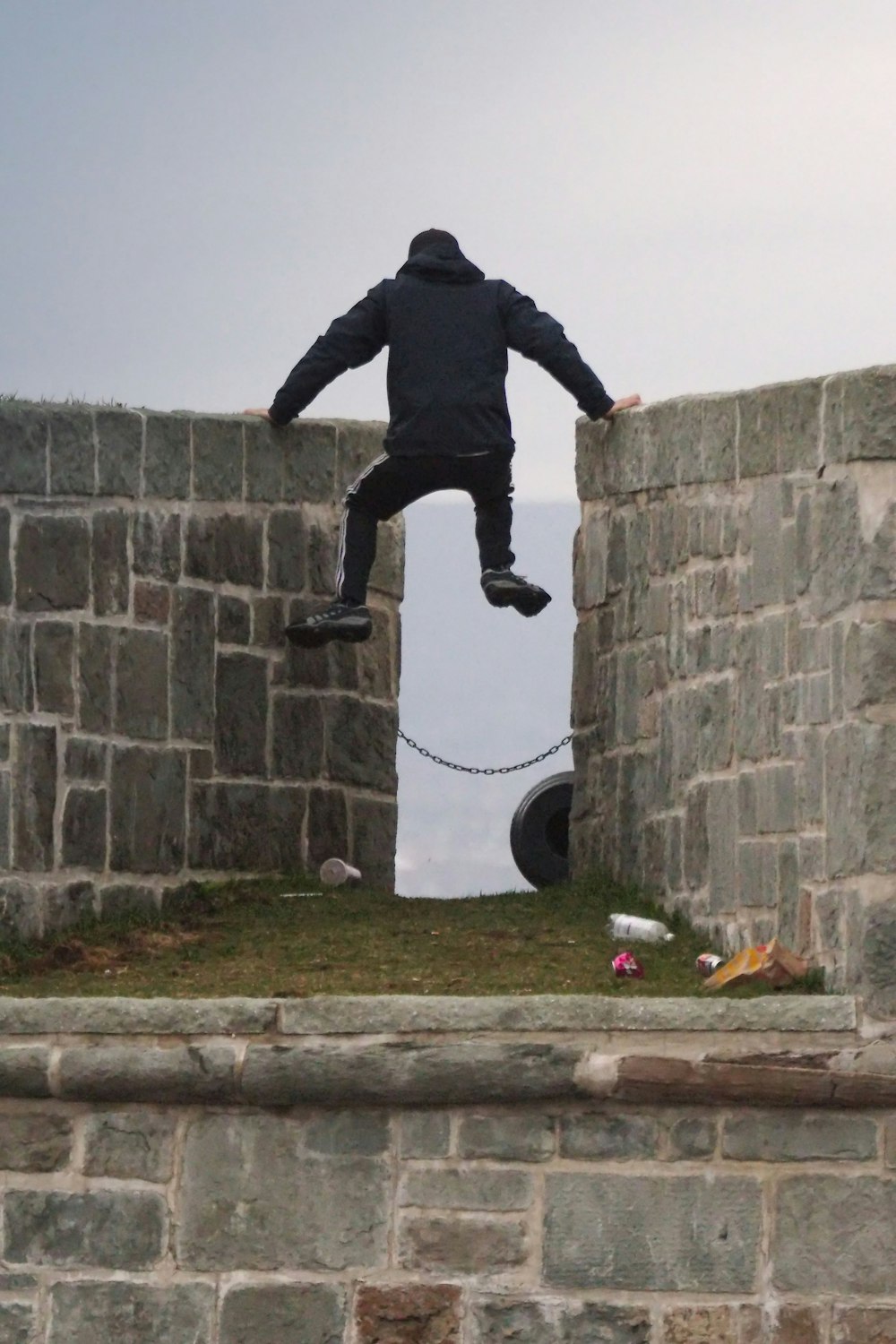 a man jumping off a wall into the air