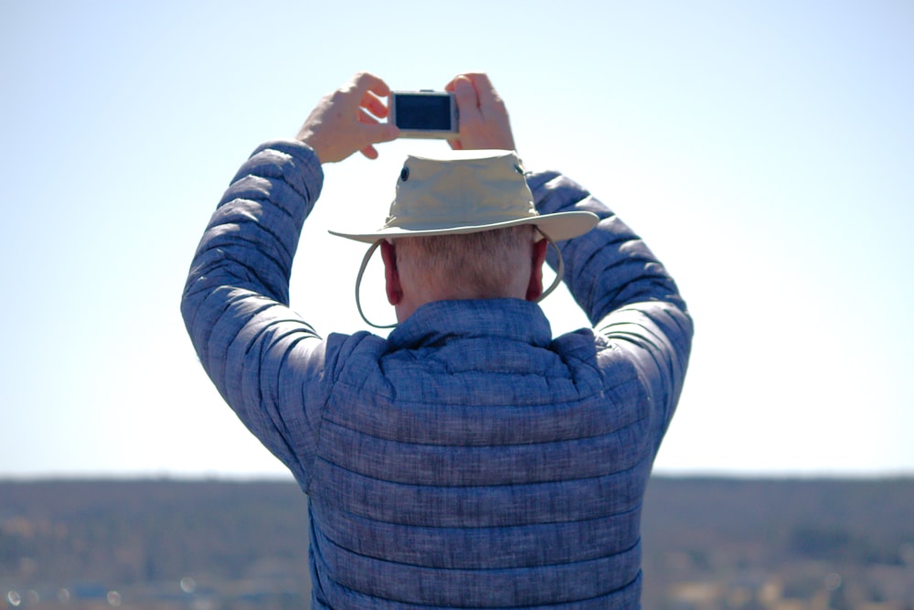 a man taking a picture with his cell phone