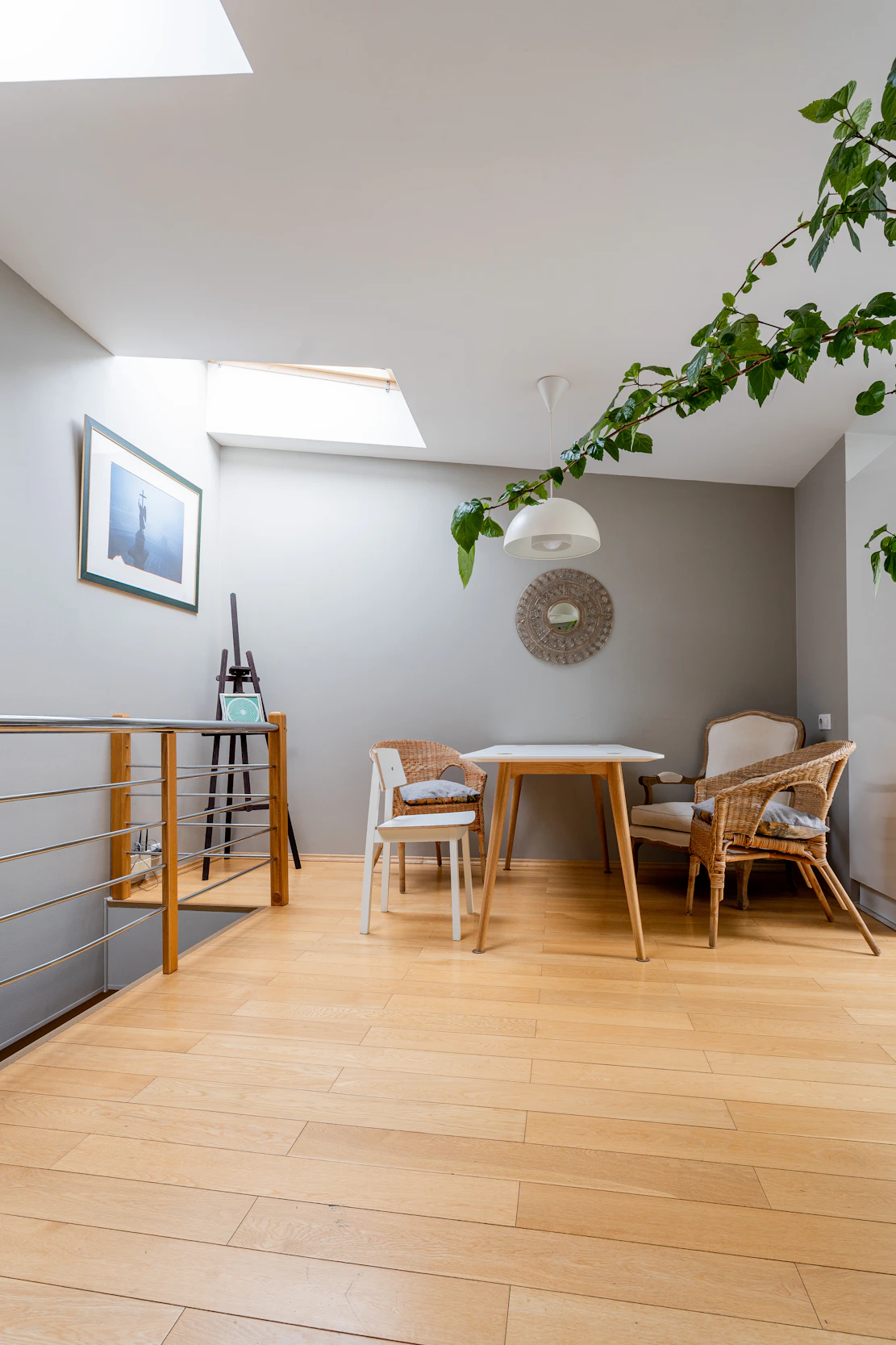 a room with a wooden floor and a table and chairs
