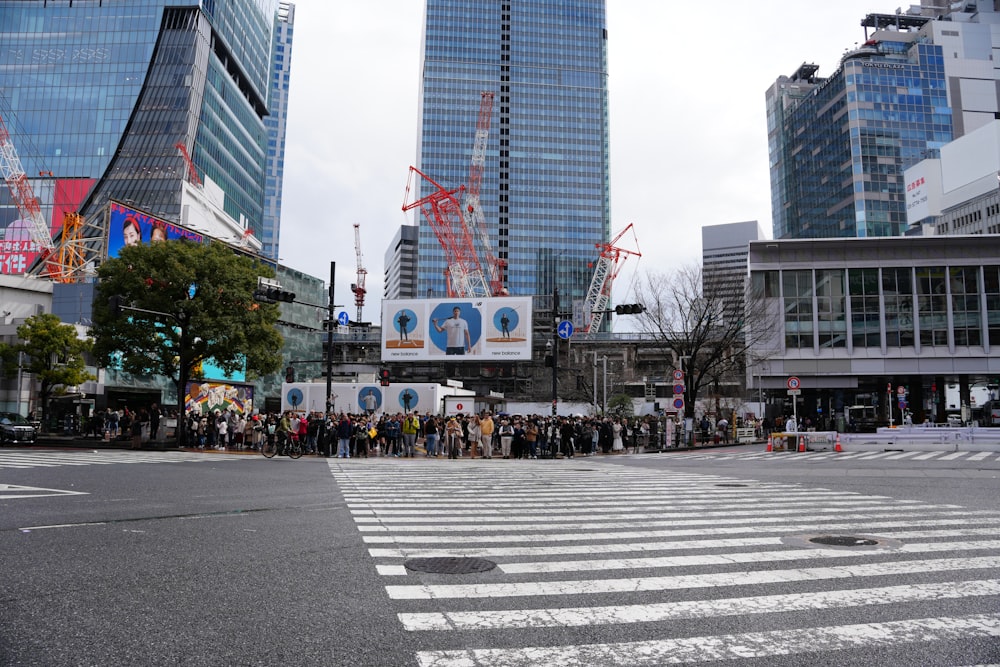 a group of people standing in the middle of a street