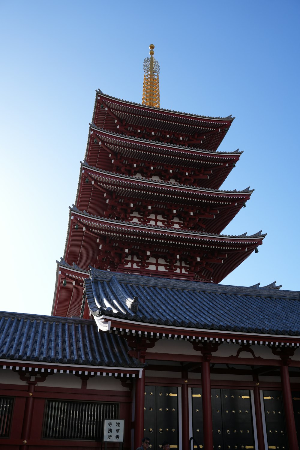 a tall building with a tall tower in the background