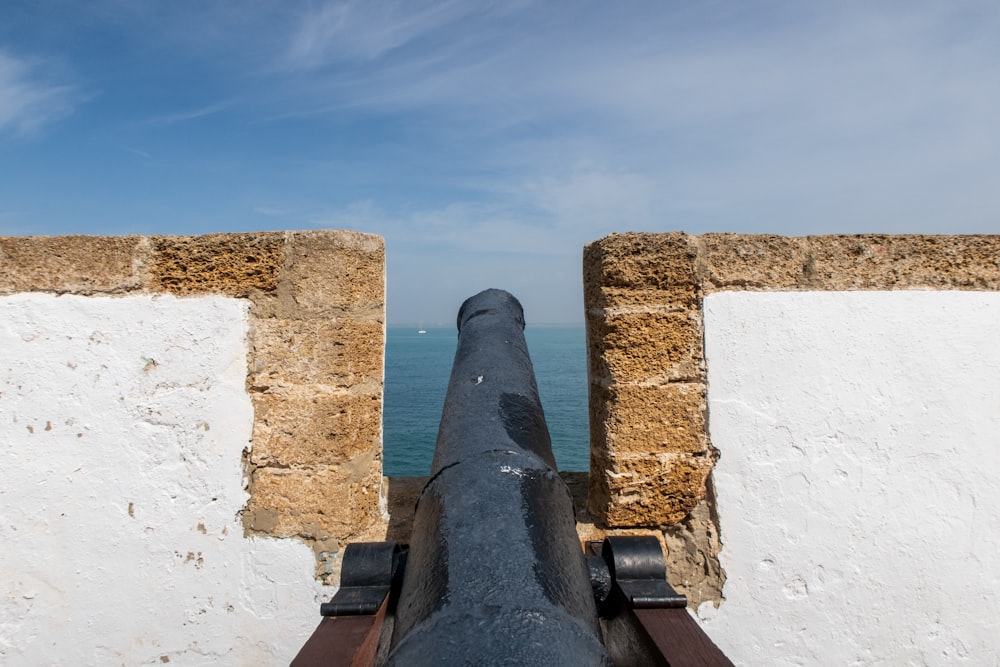 a view of the ocean from the top of a cannon
