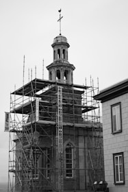 a building with scaffolding around it and a clock tower