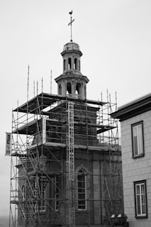a building with scaffolding around it and a clock tower
