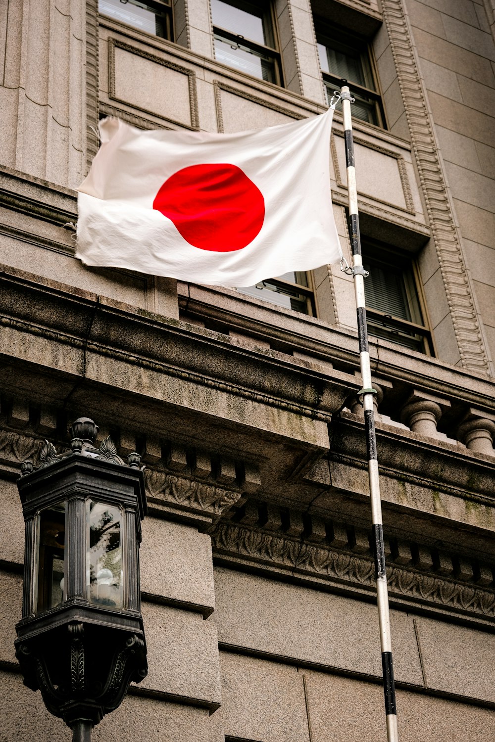 a flag flying in front of a building