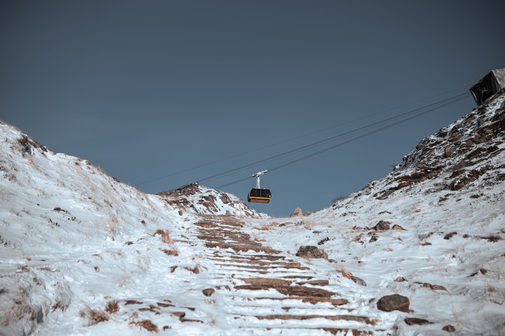 a ski lift going up a snowy mountain