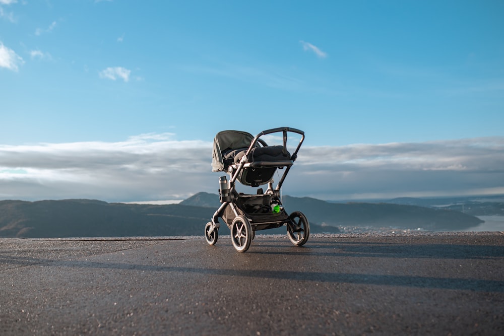 a stroller sitting on the side of a road