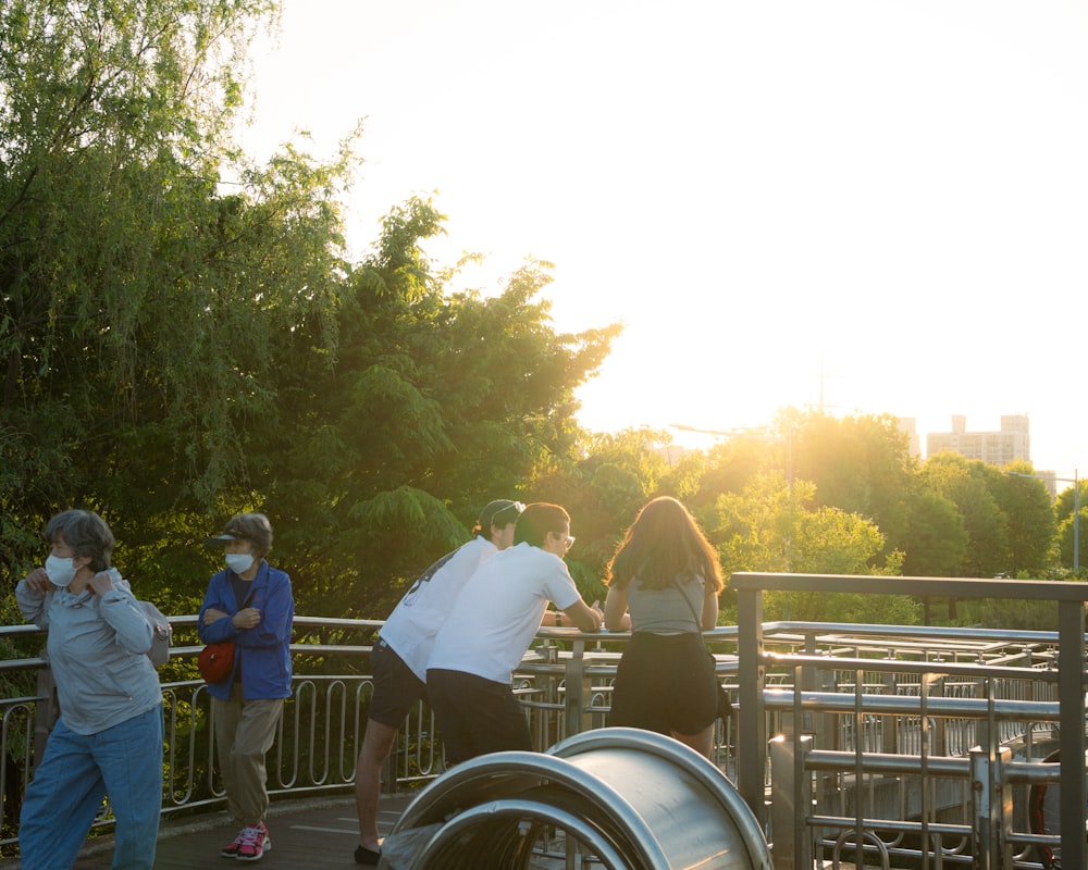 a group of people standing on top of a bridge