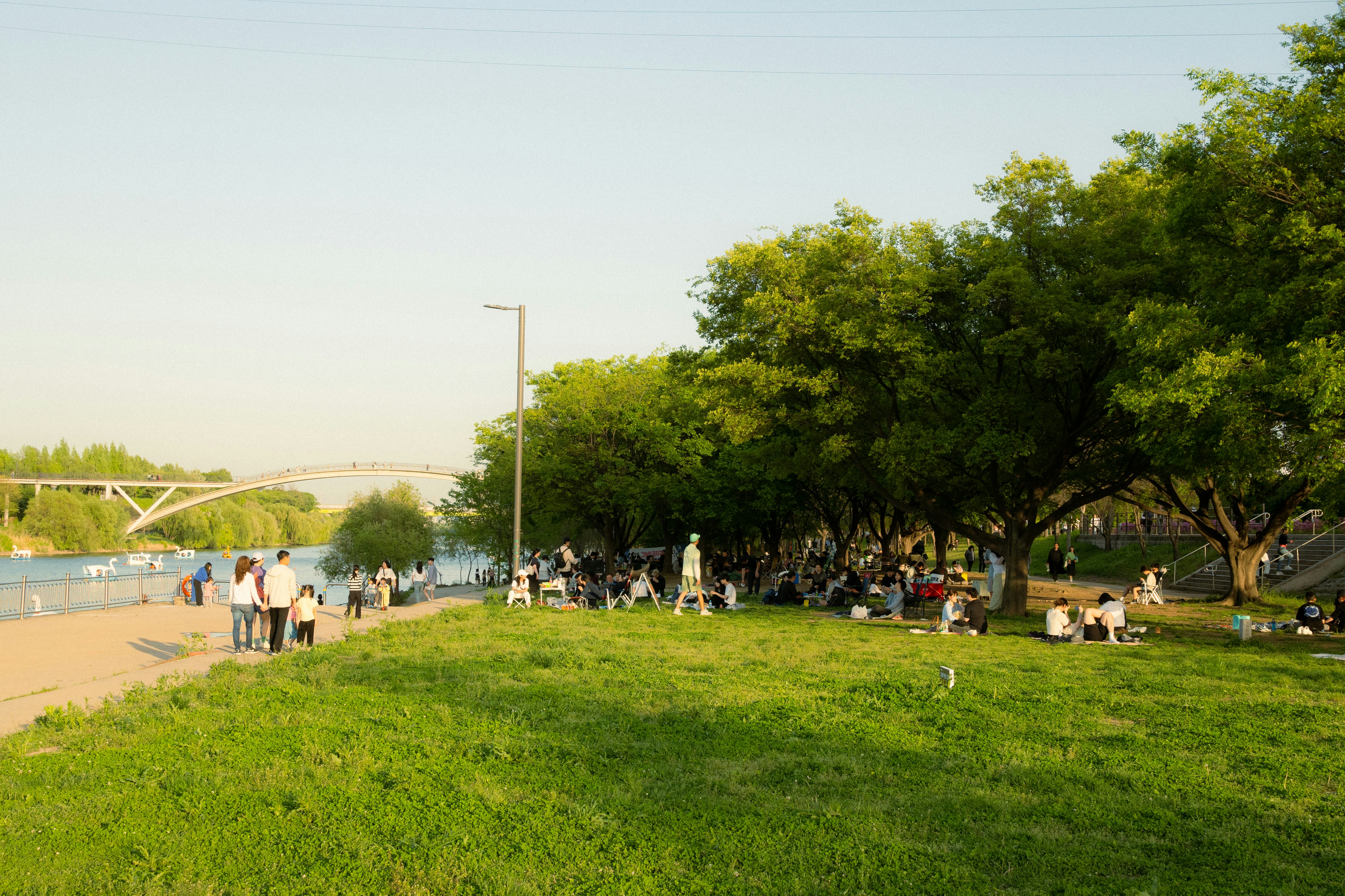 people enjoying the Chicago Riverwalk or Millennium Park - luxury apartments chicago loop