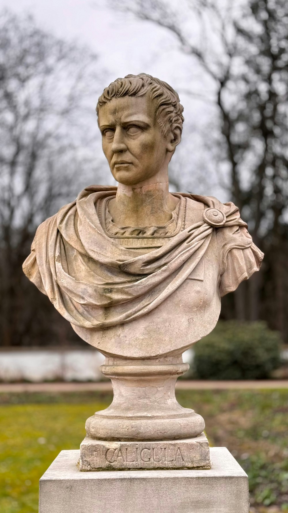 a bust of a man in a park