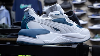a white and blue sneaker on display in a store