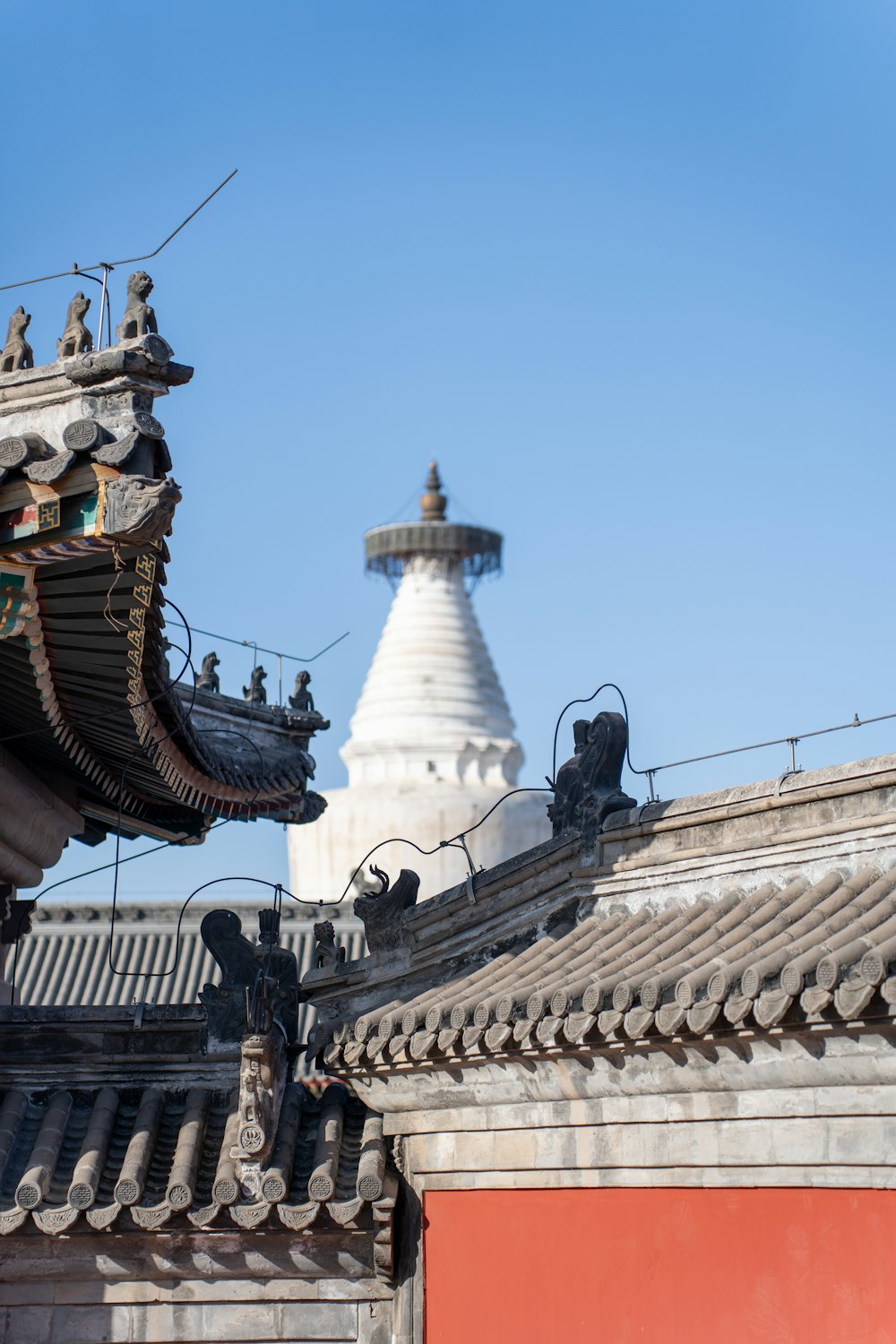 the roof of a building with a tower in the background