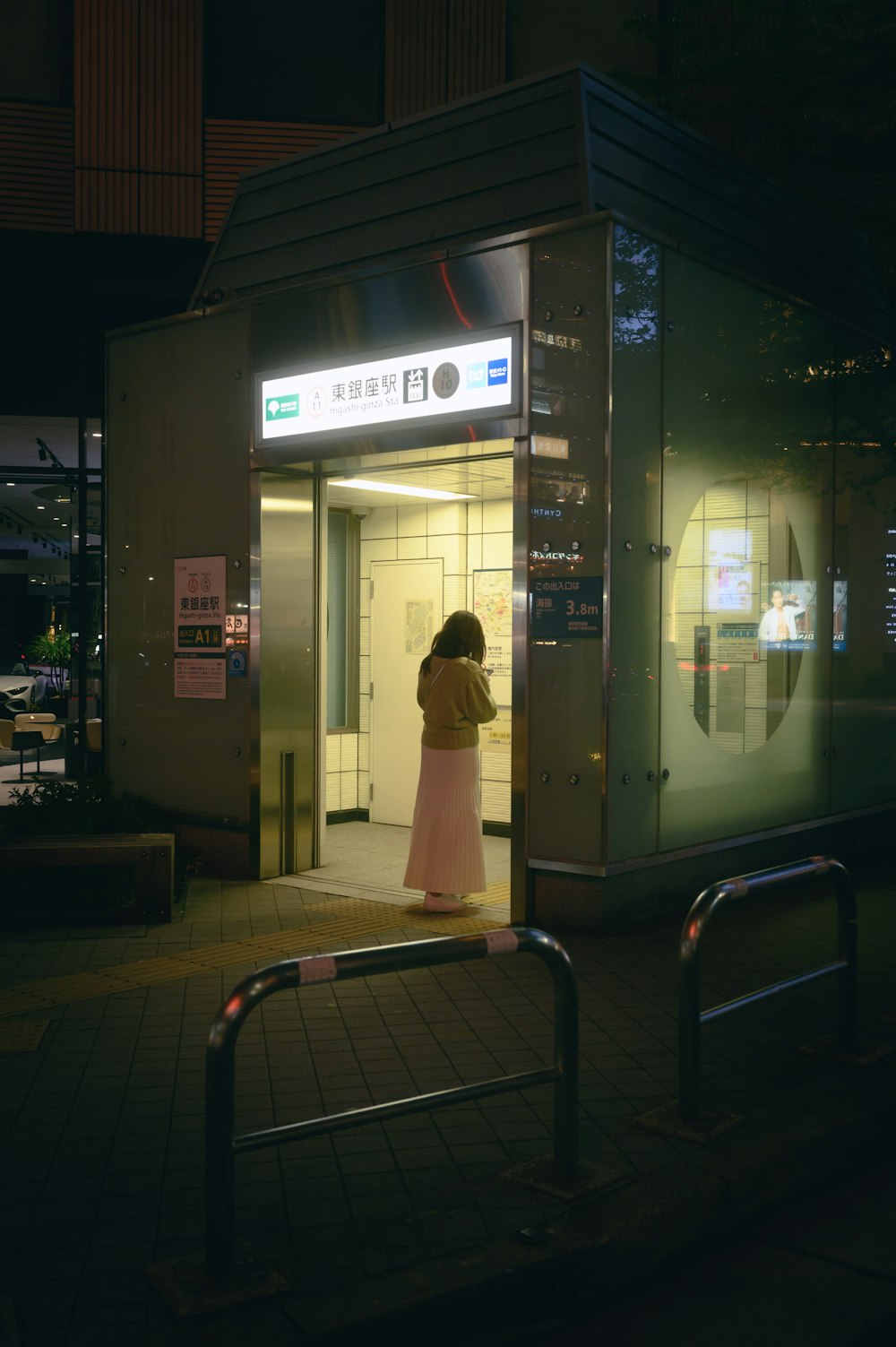 a woman standing in a doorway of a building at night