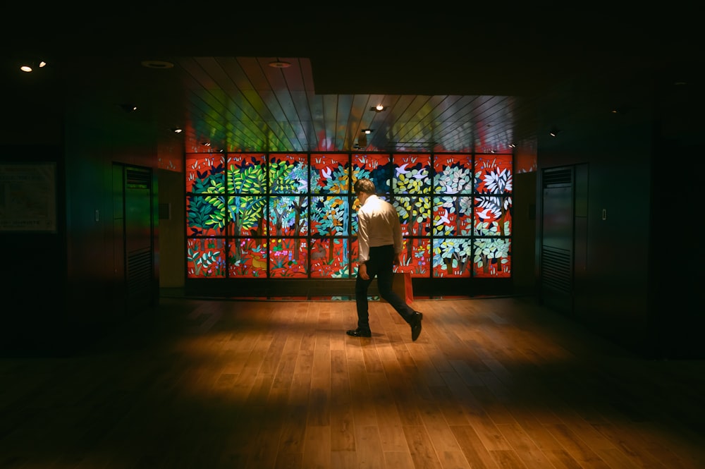 a man standing in front of a stained glass window