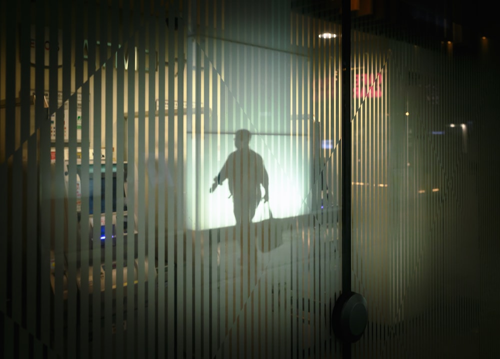 a man walking down a street at night