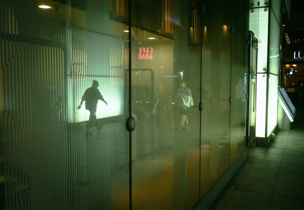 a group of people standing outside of a building at night