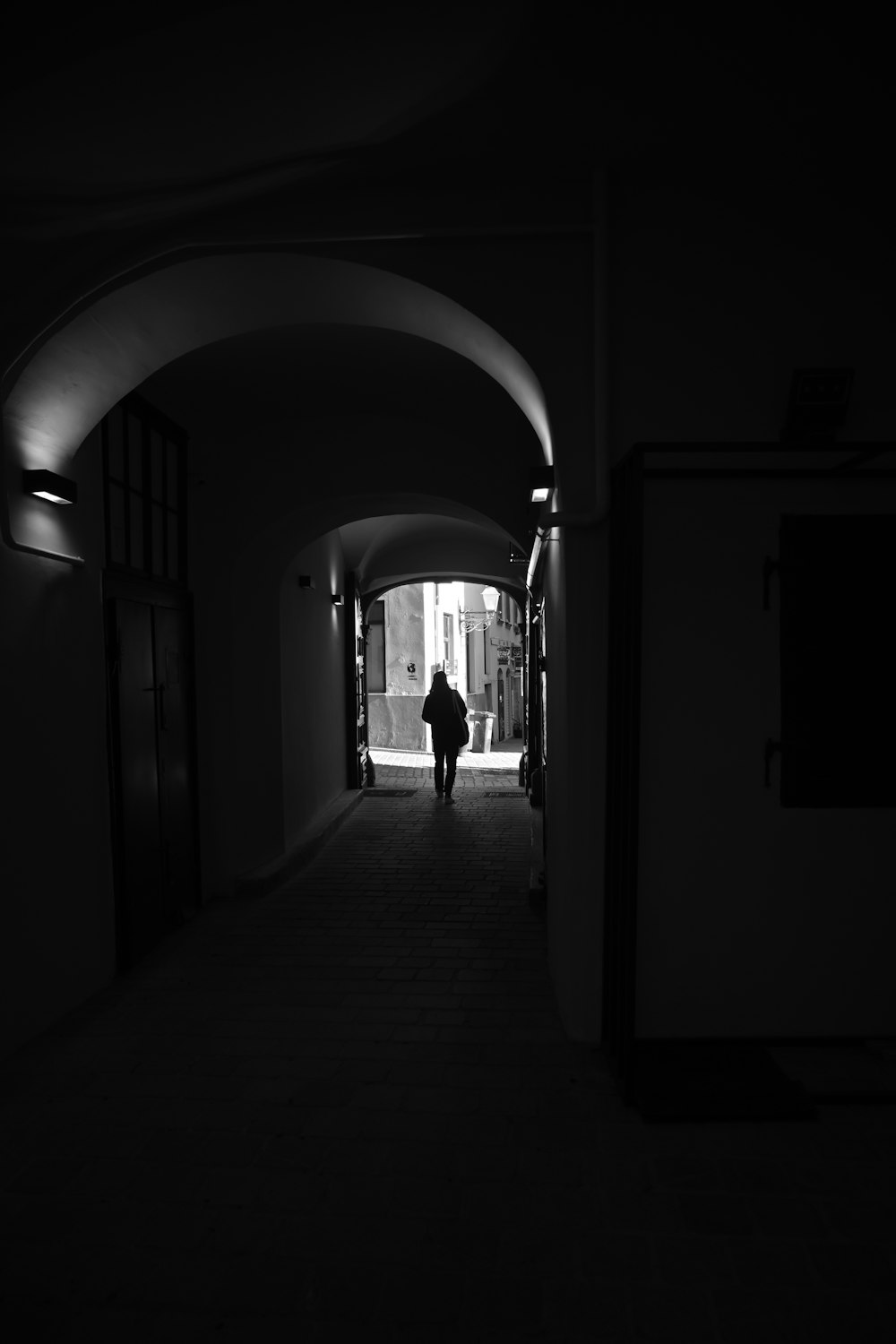 a person is walking down a dark hallway