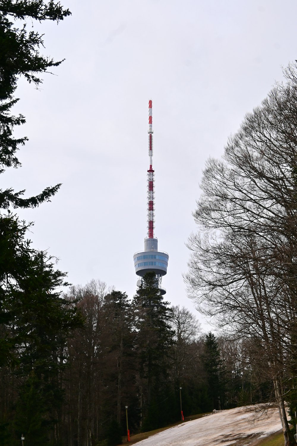 a tall tower with a red and white top