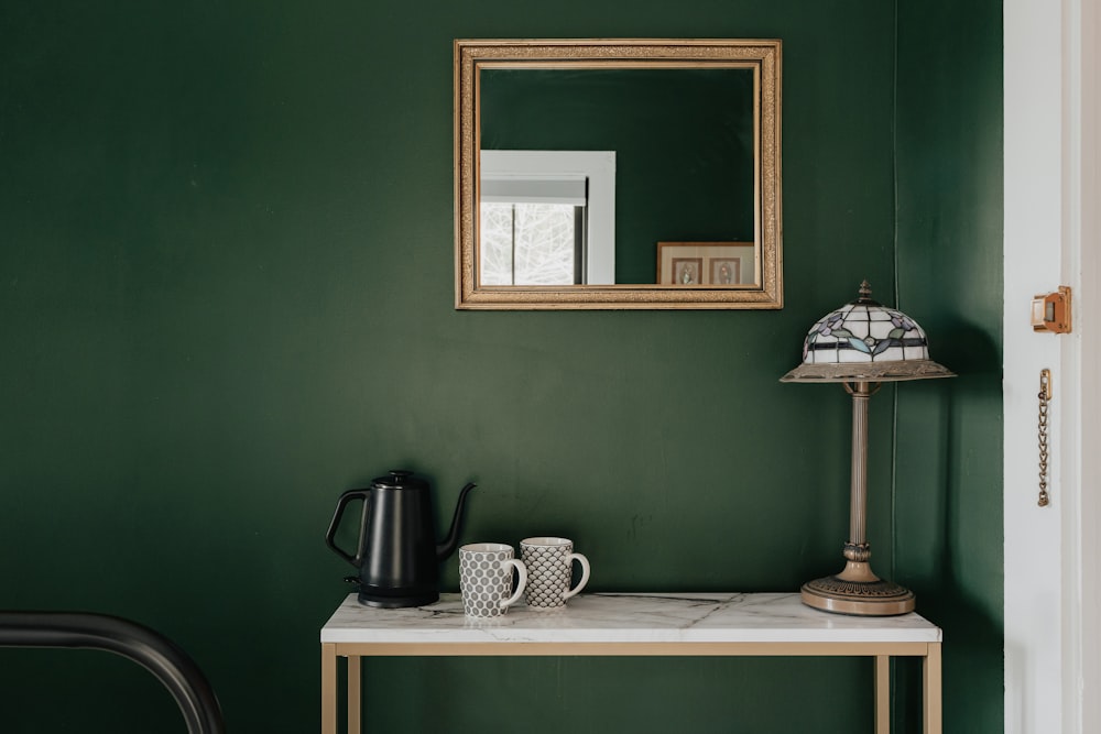 a table with a mirror and a lamp on it