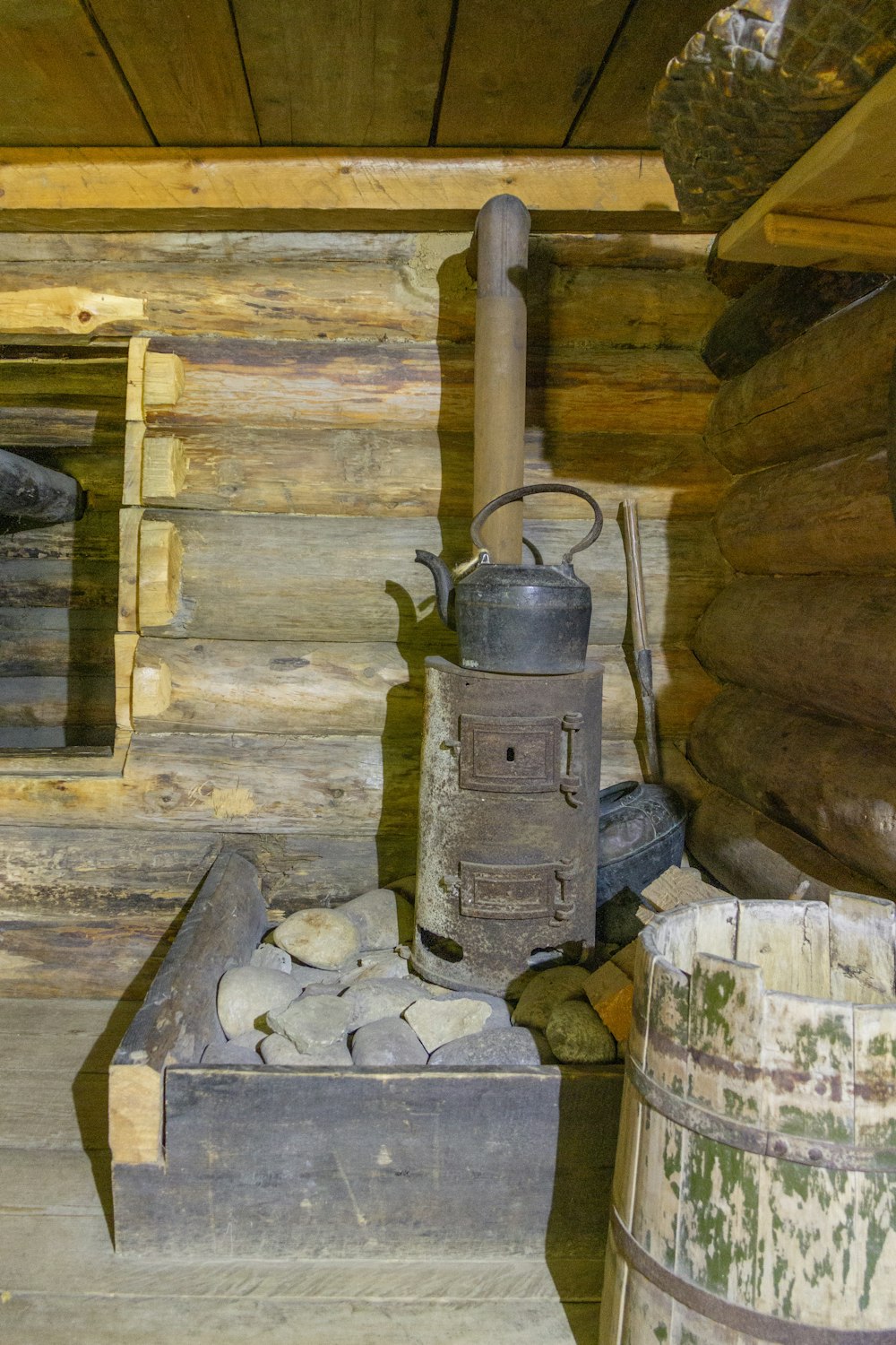 a wood stove sitting inside of a log cabin