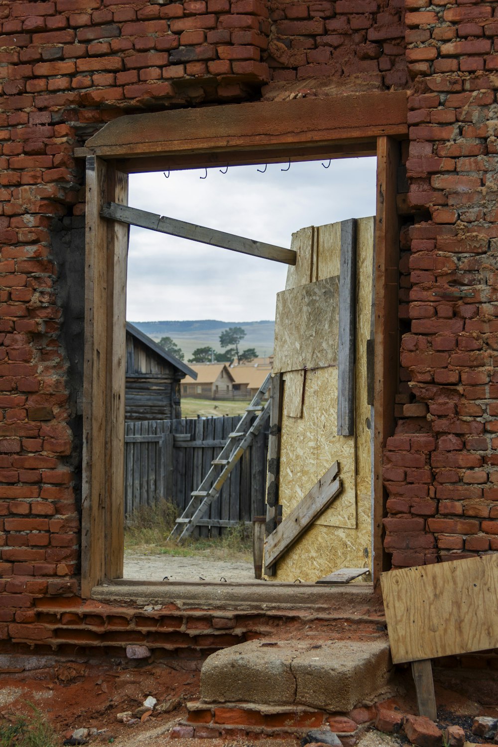 a window in a brick wall with a wooden frame
