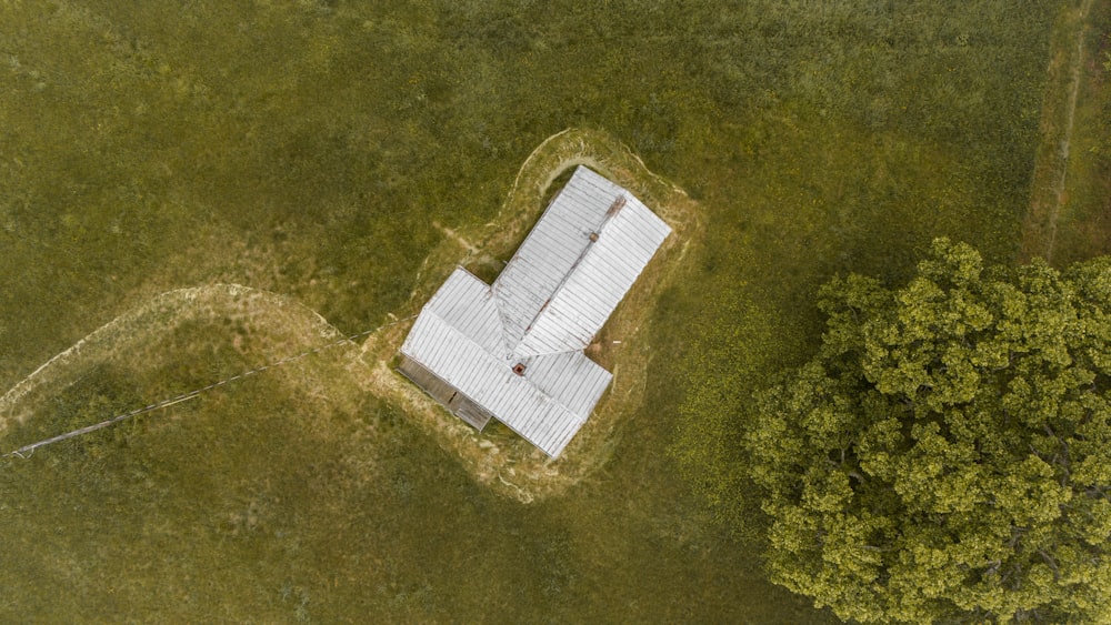 an aerial view of a building in the middle of a field