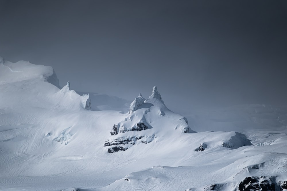 a man riding skis down a snow covered slope