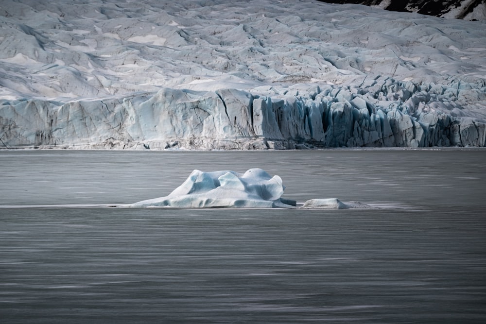 a large iceberg floating in the middle of a lake