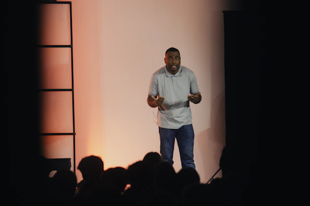 a man standing on a stage giving a presentation