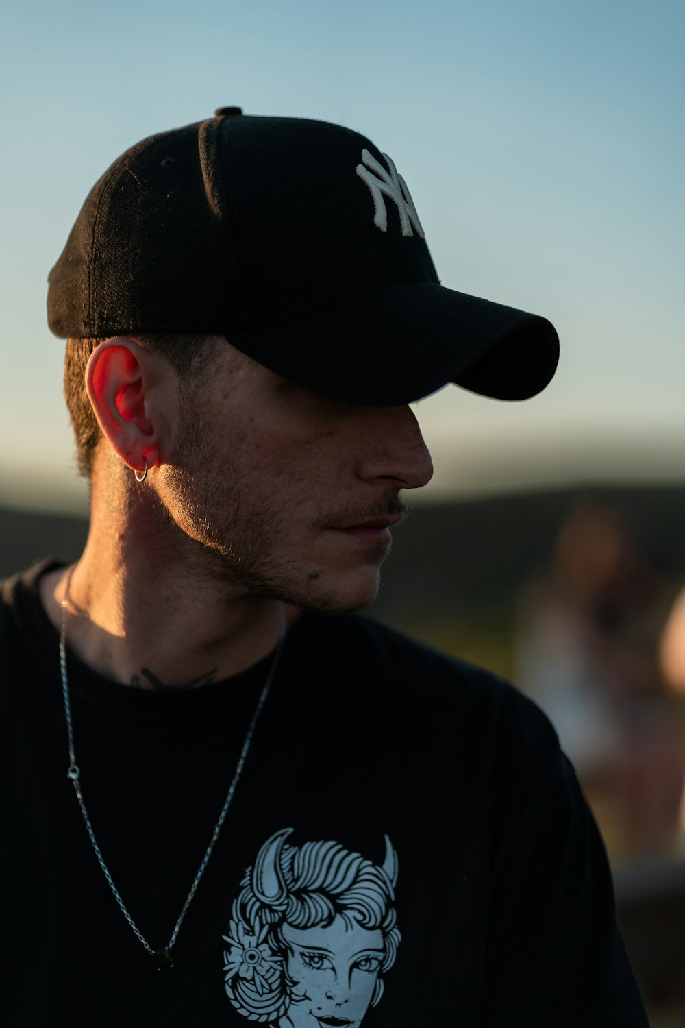 a man wearing a black hat and a black shirt