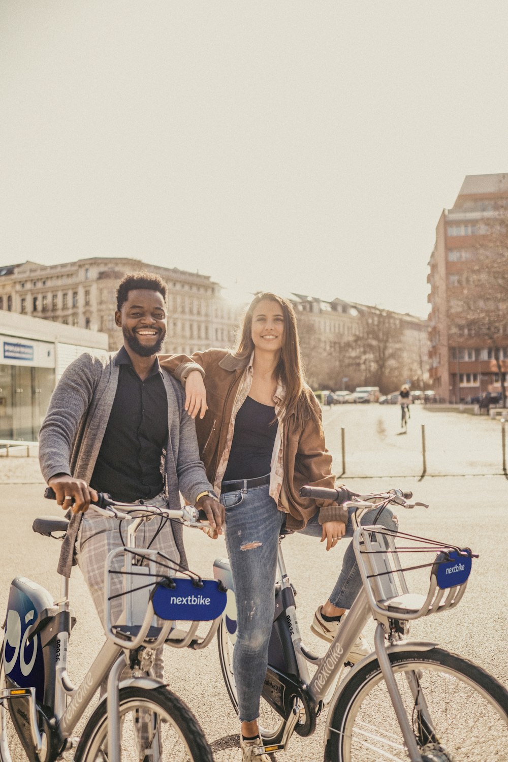 a man and a woman standing next to their bikes