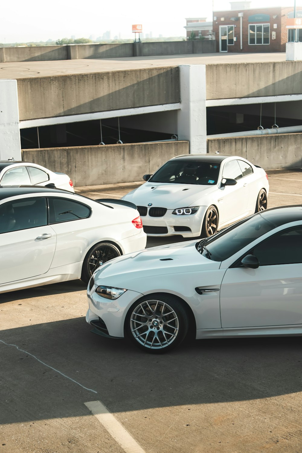 a parking lot filled with lots of white cars