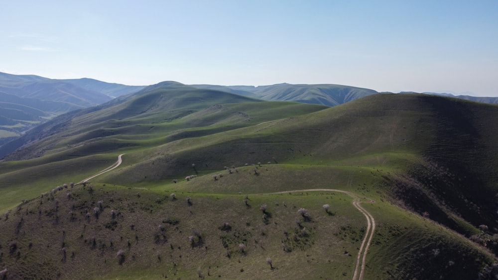 an aerial view of a winding road in the mountains