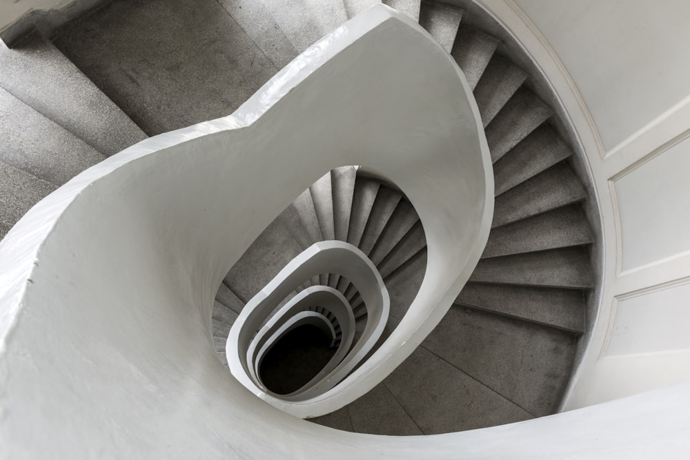 a spiral staircase in a building with concrete walls