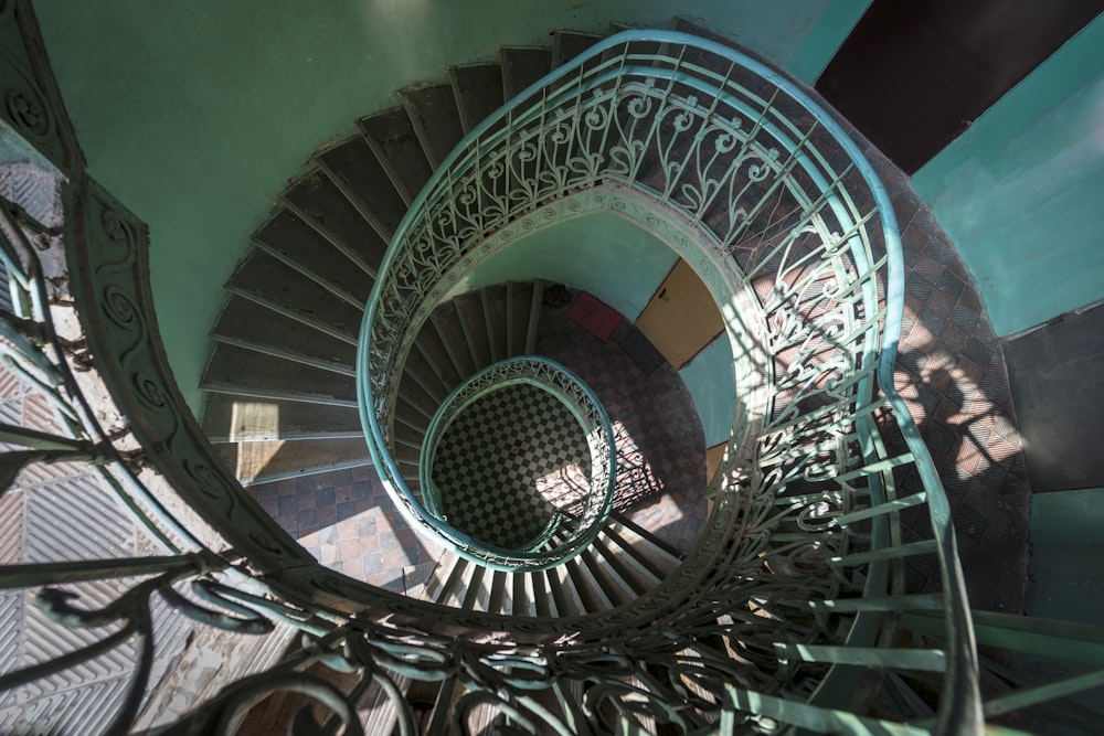 a spiral staircase in a building with wrought iron railings