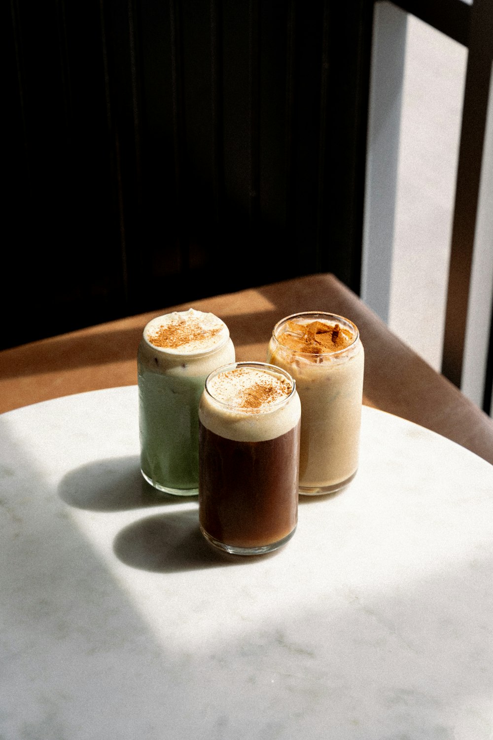 three drinks sitting on top of a white table