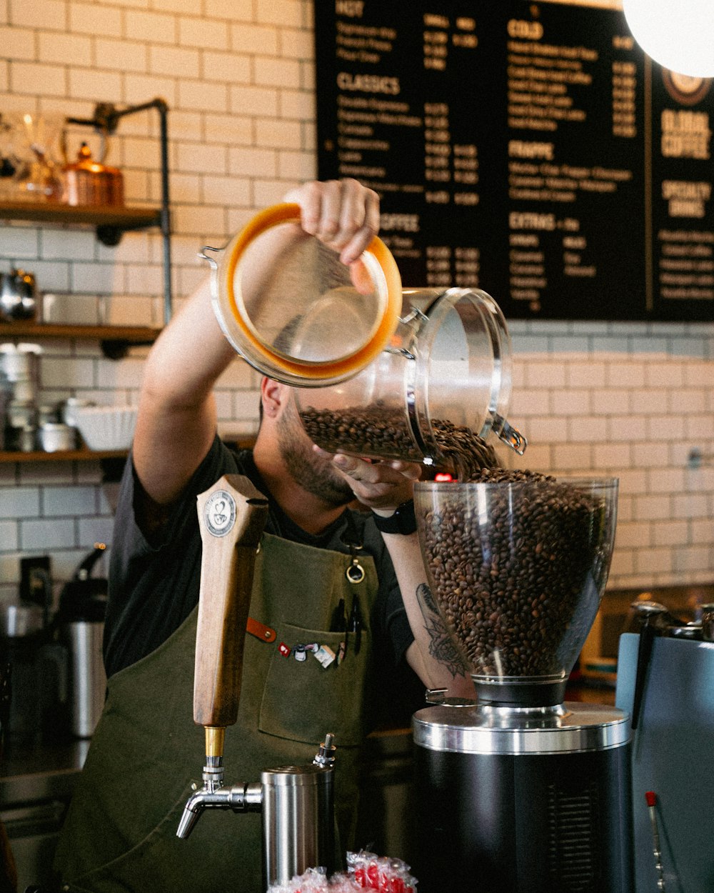 a man pouring a cup of coffee into a machine