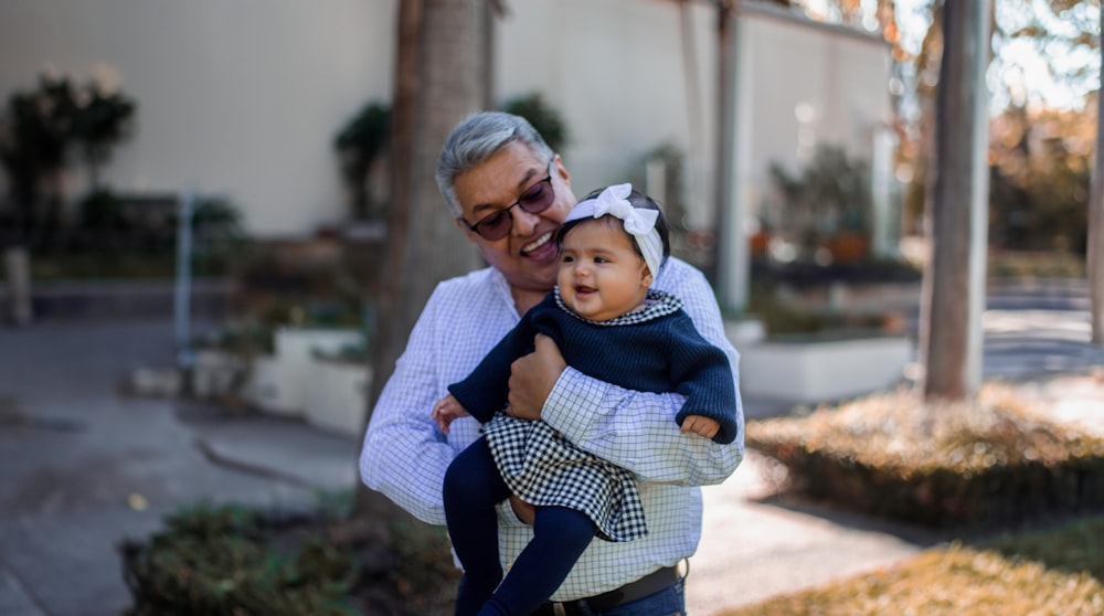 a woman holding a small child in her arms